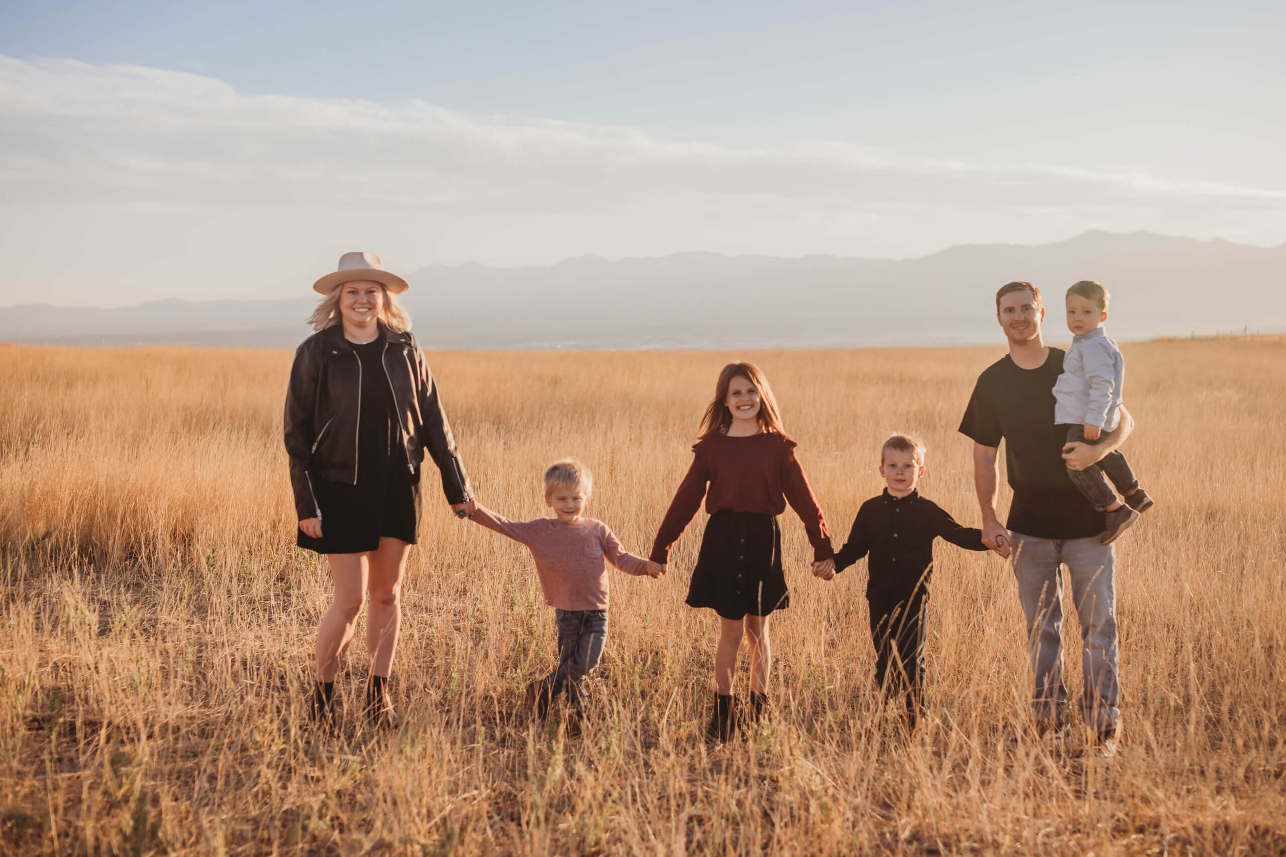 family of six standing in meadow